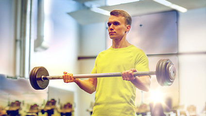 Image showing man doing exercise with barbell in gym