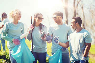 Image showing volunteers with garbage bags cleaning park area