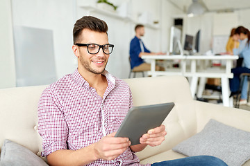 Image showing man in glasses with tablet pc working at office