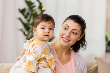 Image showing happy smiling mother with baby daughter at home