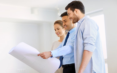 Image showing realtor showing blueprint of new home to couple