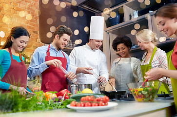 Image showing happy friends and chef cook cooking in kitchen