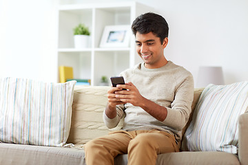 Image showing happy man with smartphone at home