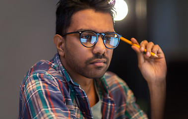 Image showing close up of creative man working at night office