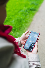 Image showing Person holding broken smartphone