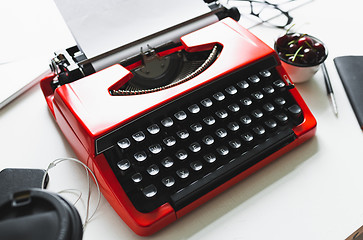 Image showing Workplace with bright red vintage typewriter