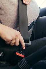 Image showing Anonymous pregnant woman wear safety belt in the car