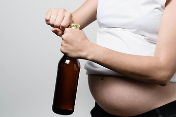 Image showing Pregnant woman with beer bottle