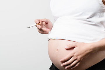 Image showing Pregnant woman smoking cigarette.