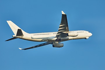 Image showing Plane taking off against clear blue sky