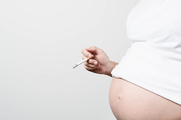 Image showing Pregnant woman smoking cigarette.