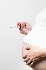 Image showing Pregnant woman smoking cigarette.