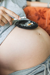 Image showing Pregnant woman smokes a cigarette