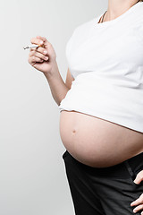 Image showing Pregnant woman smoking cigarette.