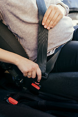 Image showing Anonymous pregnant woman wear safety belt in the car