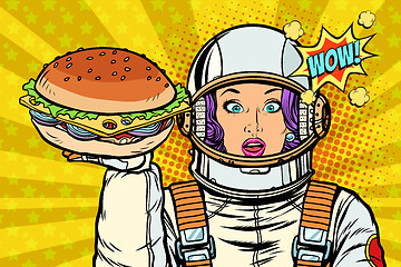 Image showing Hungry woman astronaut with Burger