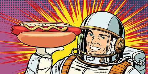 Image showing Smiling male astronaut presents hot dog sausage