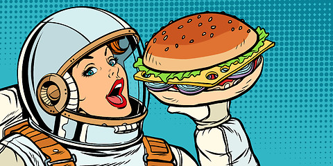 Image showing Hungry woman astronaut eating Burger