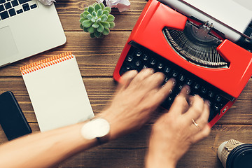 Image showing Top view of man using typewriter