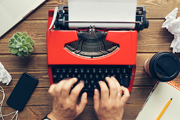 Image showing Top view of man using typewriter