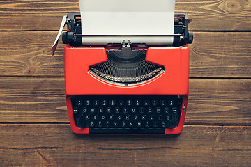 Image showing Vintage typewriter on wooden background