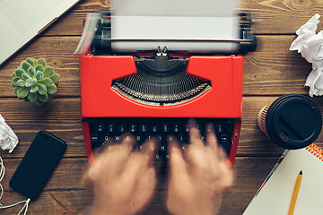 Image showing Top view of man using typewriter