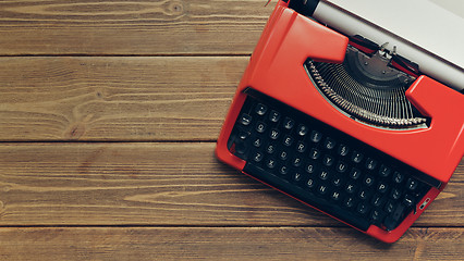 Image showing Vintage typewriter on wooden background