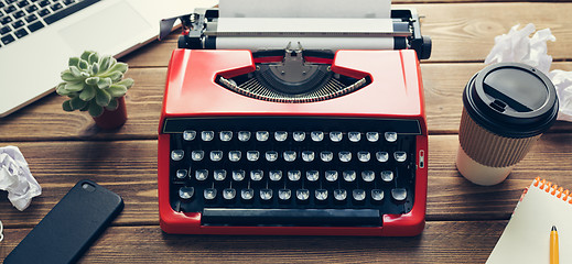 Image showing Vintage typewriter on wooden background