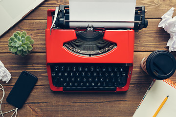 Image showing Vintage typewriter on wooden background