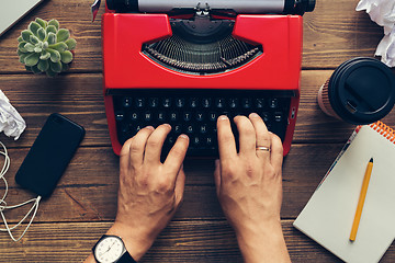 Image showing Top view of man using typewriter