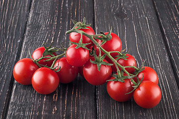 Image showing Branches cherry tomatoes on wooden table