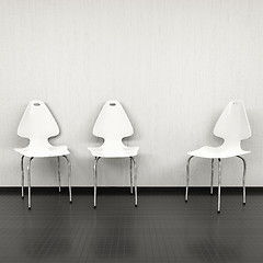 Image showing three white chairs at a wall with space for your content