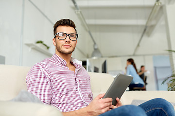 Image showing man in glasses with tablet pc working at office