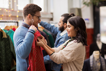 Image showing couple choosing clothes at vintage clothing store