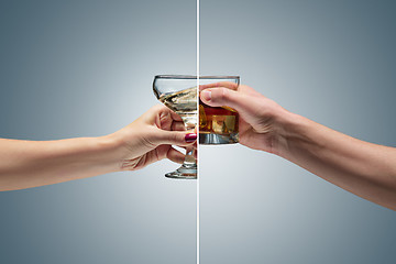 Image showing Hand holding a glass of whiskey