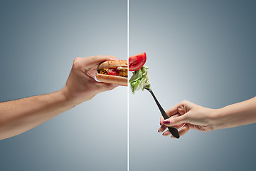 Image showing Male hand holding tasty hamburger