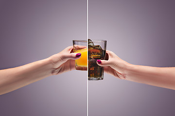 Image showing beautiful woman holding orange juice