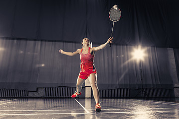 Image showing Young woman playing badminton at gym