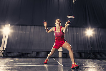 Image showing Young woman playing badminton at gym