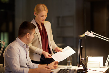 Image showing business team with papers working late at office