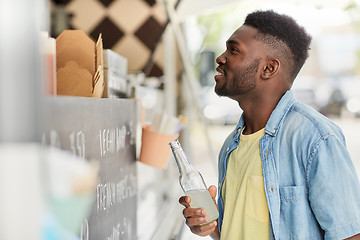 Image showing african american man with drink at food truck