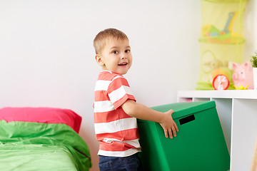 Image showing happy little boy with toy box at home