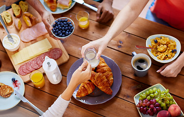 Image showing people having breakfast at table with food
