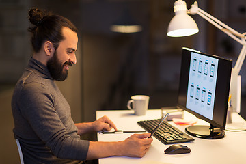 Image showing man with smartwatch and tablet pc at night office