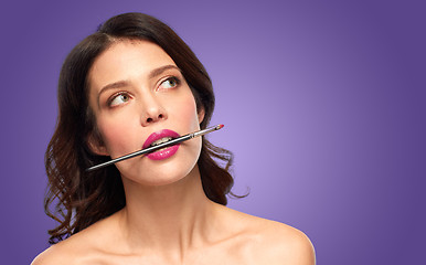 Image showing beautiful woman with make up brush for lipstick