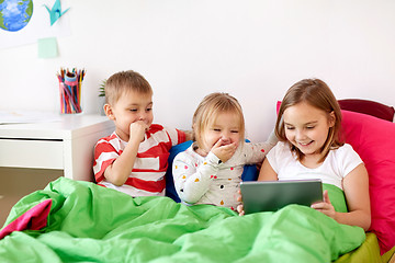 Image showing little kids with tablet pc in bed at home