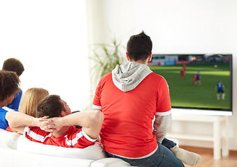 Image showing football fans watching soccer game on tv at home