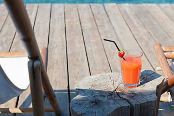 Image showing Wooden floor with chaise-longues and cocktail