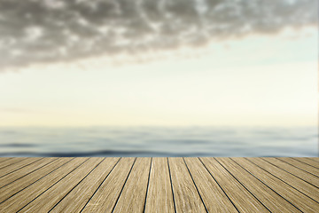 Image showing wooden jetty with blurred ocean background