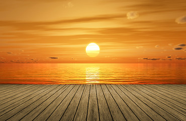 Image showing a beautiful golden sunset over the ocean and a wooden jetty